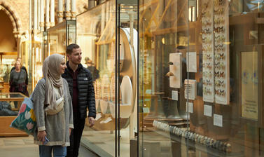 Two visitors enjoying a butterfly display