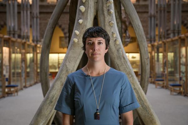 Kelley Swain in front of a Sperm Whale jawbone in the Museum's main court