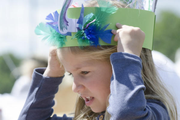 Girl wearing paper peacock headdress 