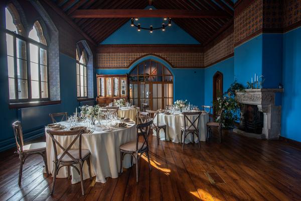 The historic westwood room furnished with tables and chairs ready for a wedding reception